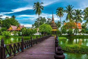 A walkway to a temple across a lake