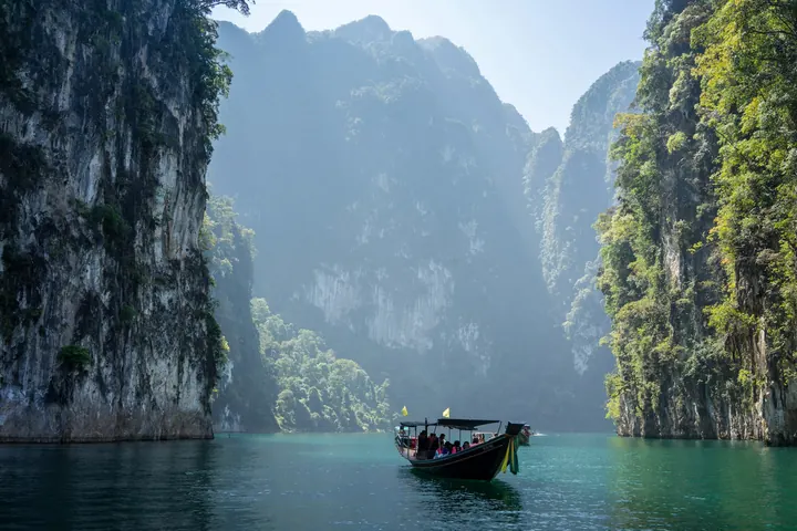 Limestone cliffs rising above a jungle lake