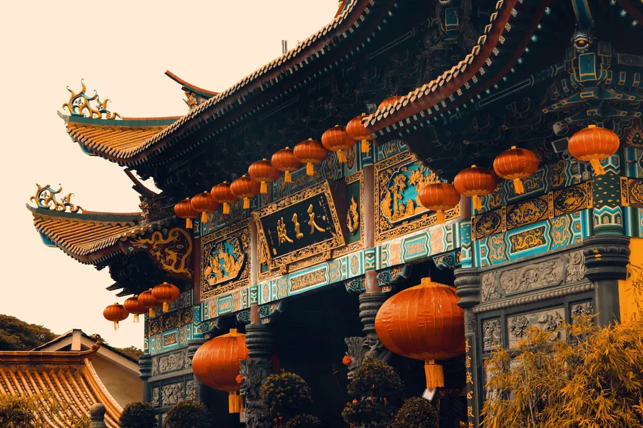 Ornate temple gateway hung with red lanterns