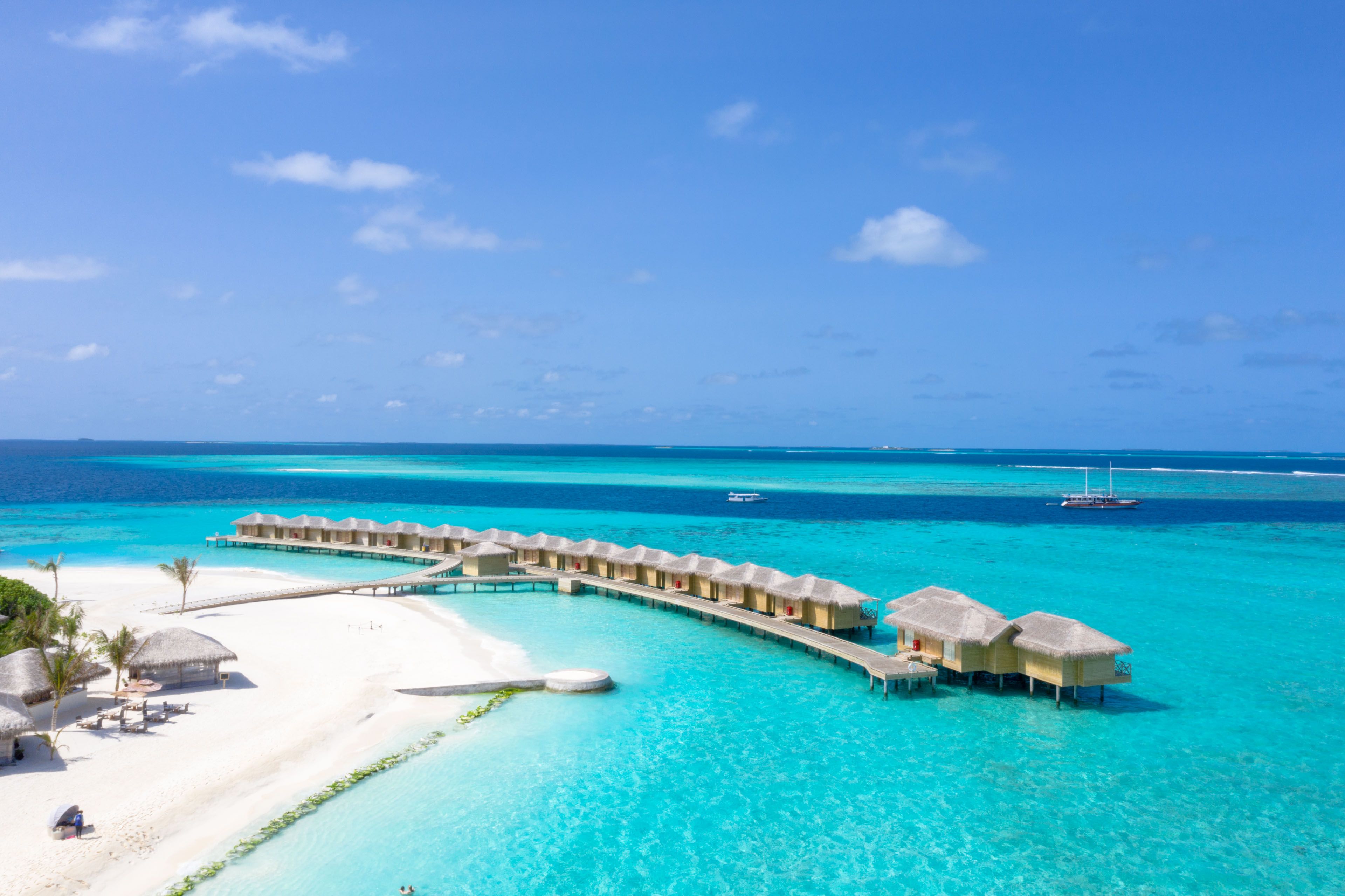 Overwater villas on a turquoise lagoon
